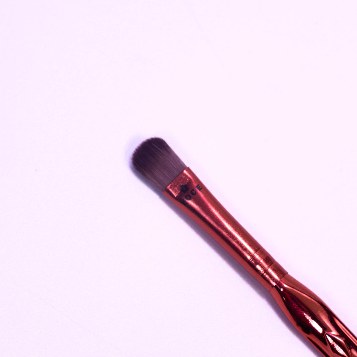 Zoni Stores Voce Finger Buffer Makeup Brush showing a hand holding the brush for seamless blending and makeup application.