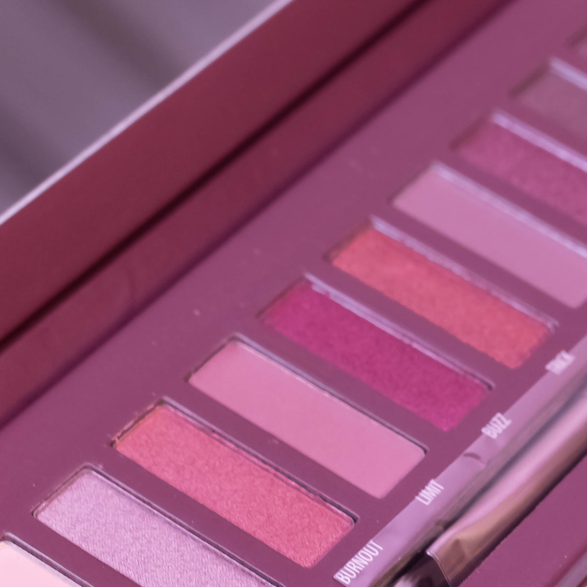 HUDABEAUTY 12-Color Eyeshadow Case by Zoni Stores with vibrant, shimmery eye makeup shades in a sleek palette.
