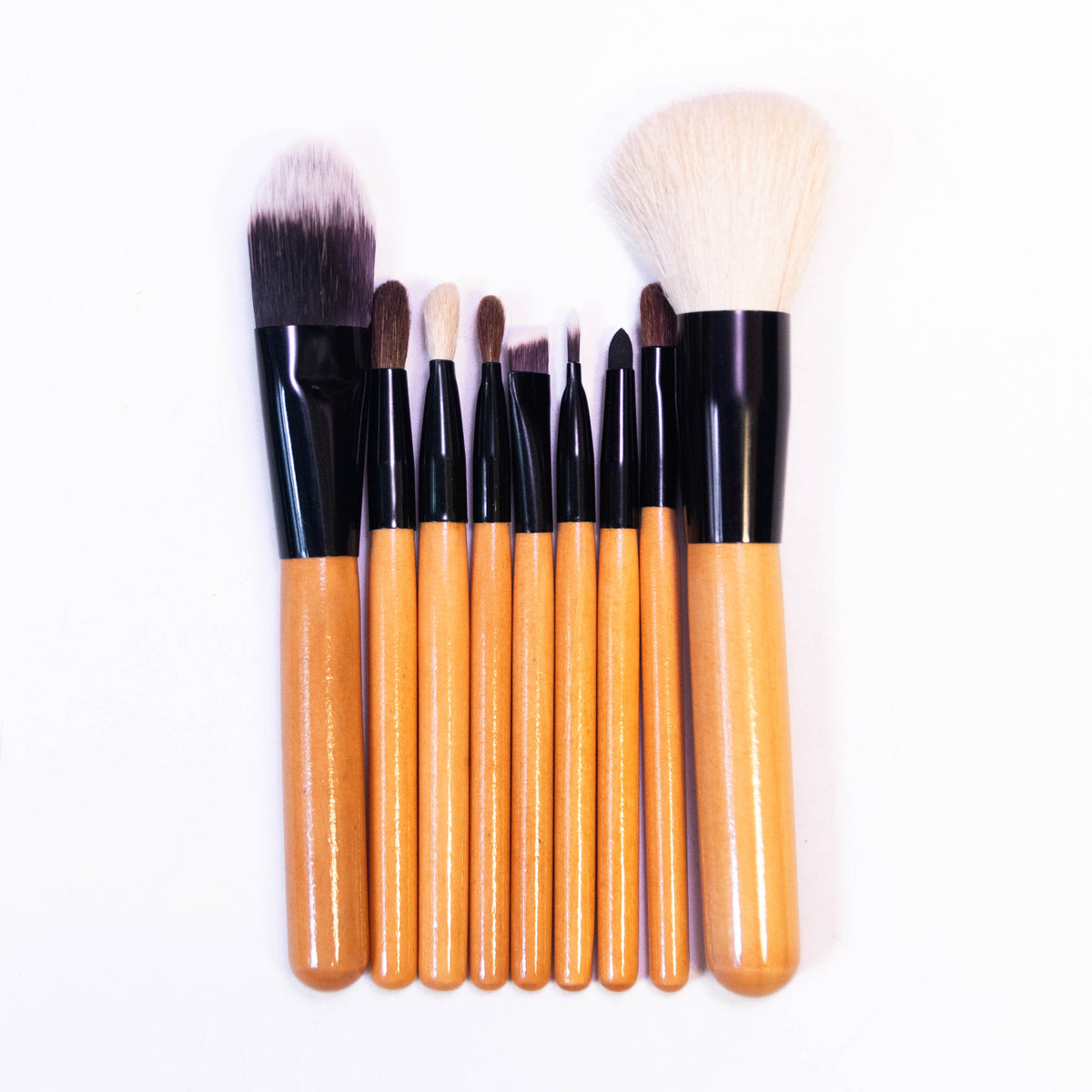 Set of nine Zoni Stores LAROC Cosmetics makeup brushes with various sizes and shapes for professional makeup application.