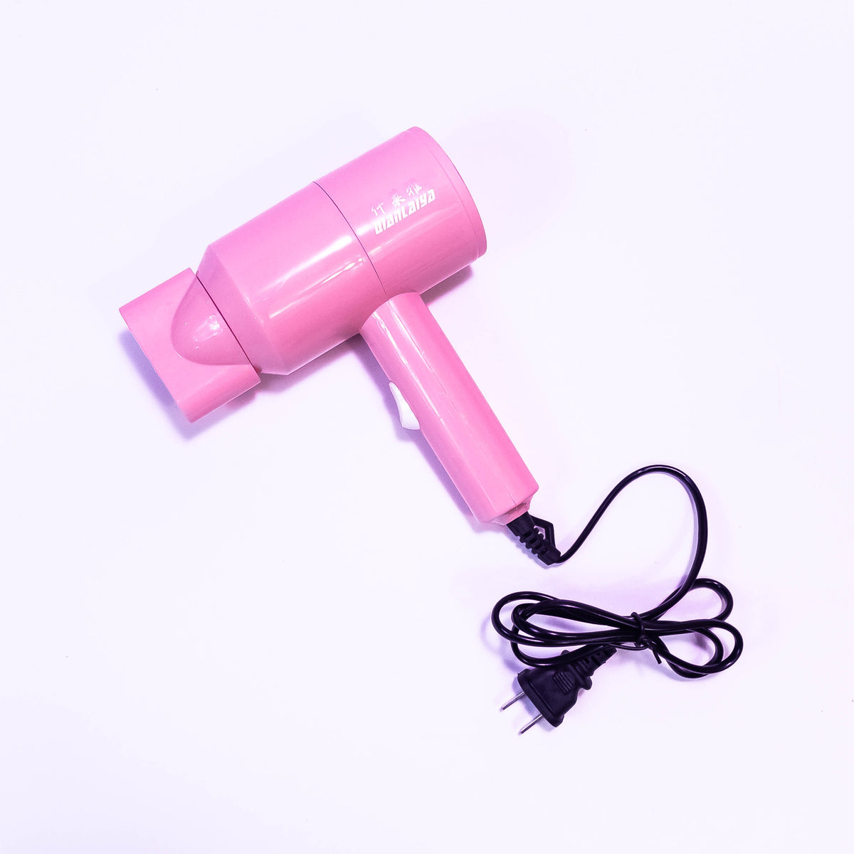 Zoni Stores Mini Star Hair Dryer with compact design and black finish, showing the front view with airflow vents and control buttons.