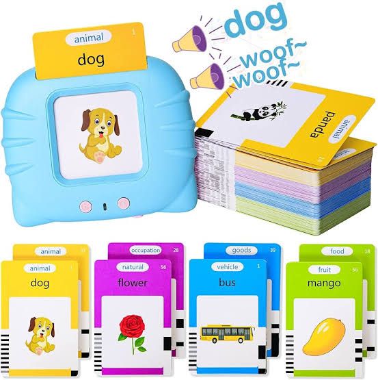 A compact rechargeable talking flash card learning device surrounded by stacks of colorful educational vocabulary cards and a USB charging cable