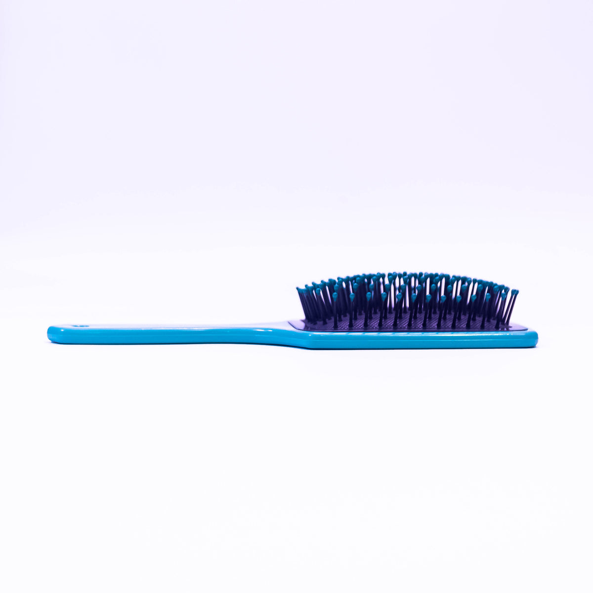 Sky blue printed hair brush by Zoni Stores with ergonomic design, suitable for detangling and styling hair.