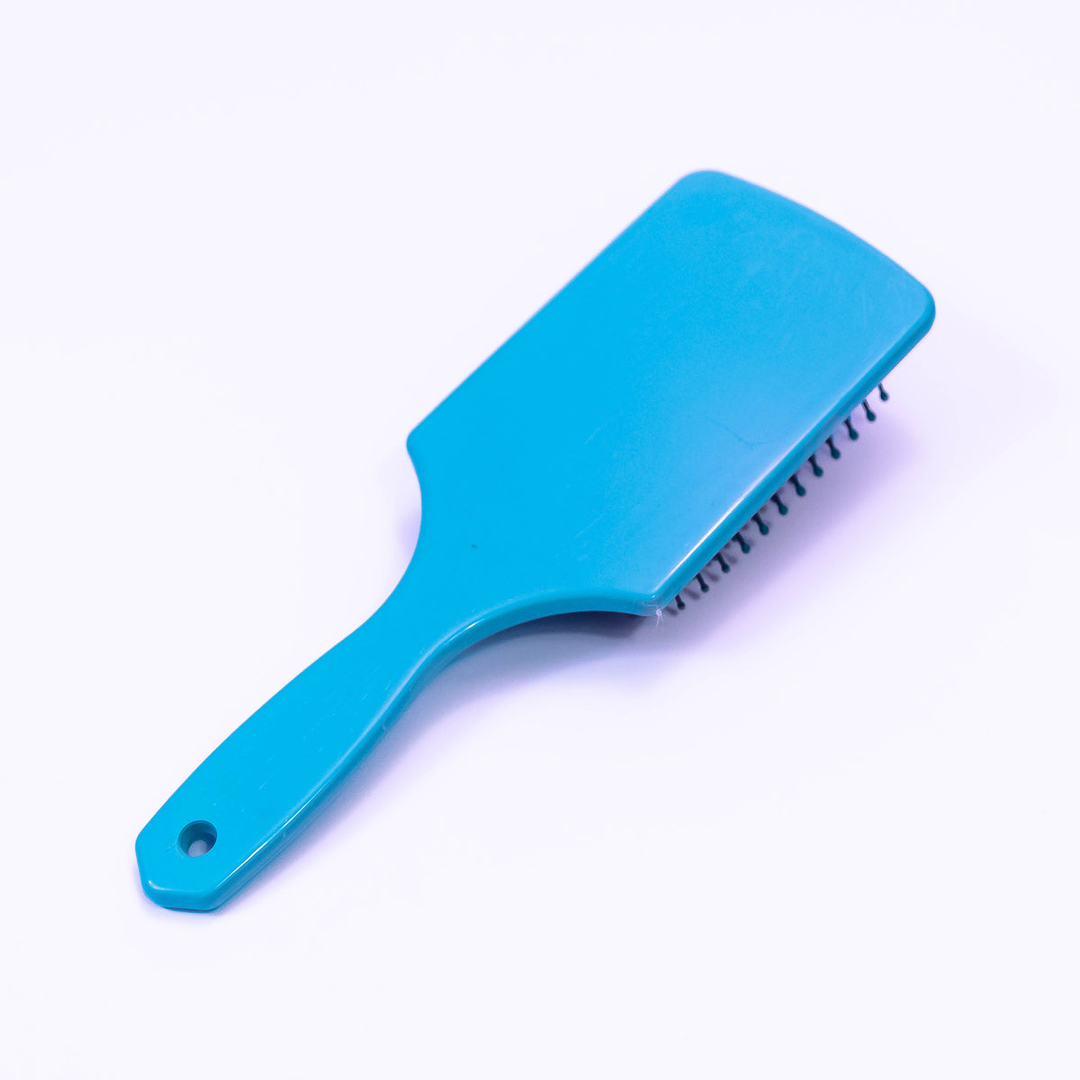 Sky blue printed hair brush by Zoni Stores, showing the colorful patterned bristles and ergonomic handle for styling.