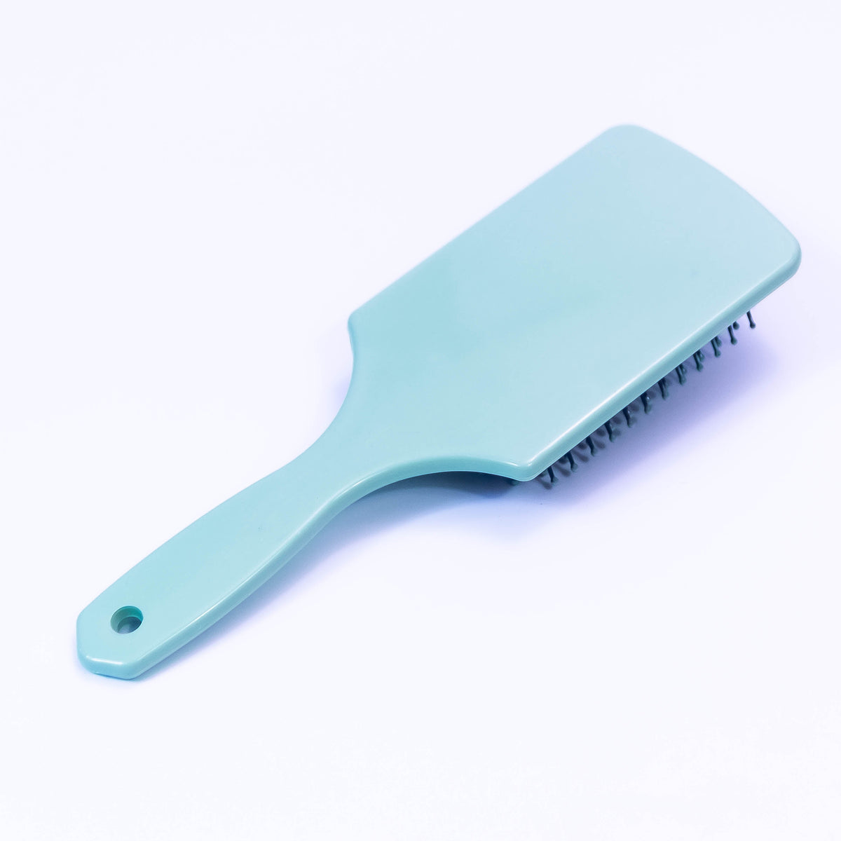 Printed sea green hair brush by Zoni Stores, showing the detailed design and bristles on a sleek, colorful hair grooming tool.