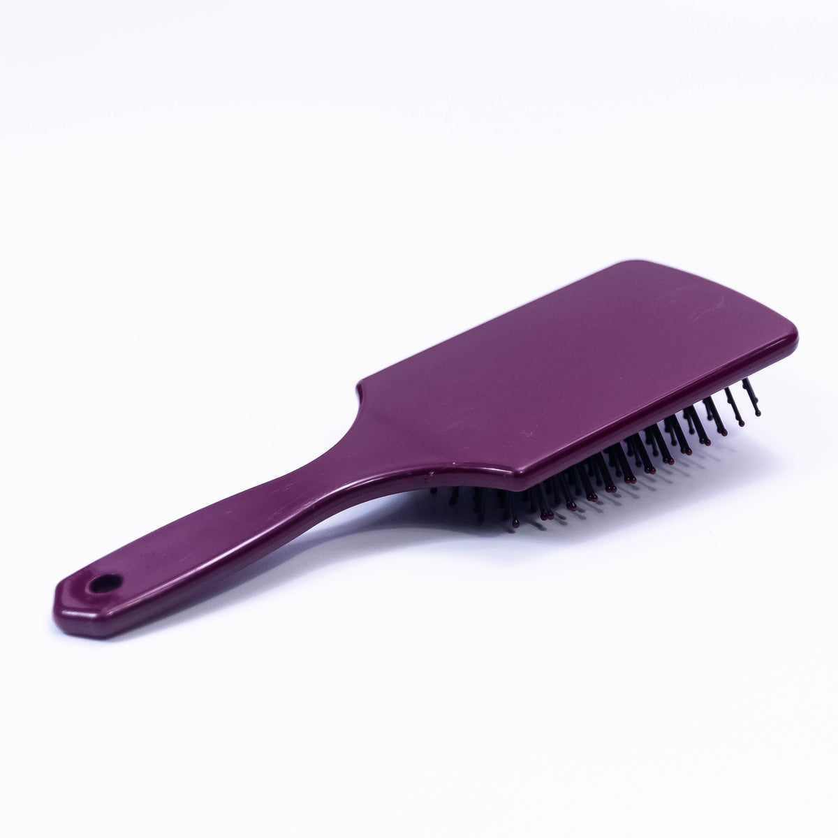 Printed Choco Color Hair Brush by Zoni Stores with ergonomic handle and bristles for gentle hair detangling.