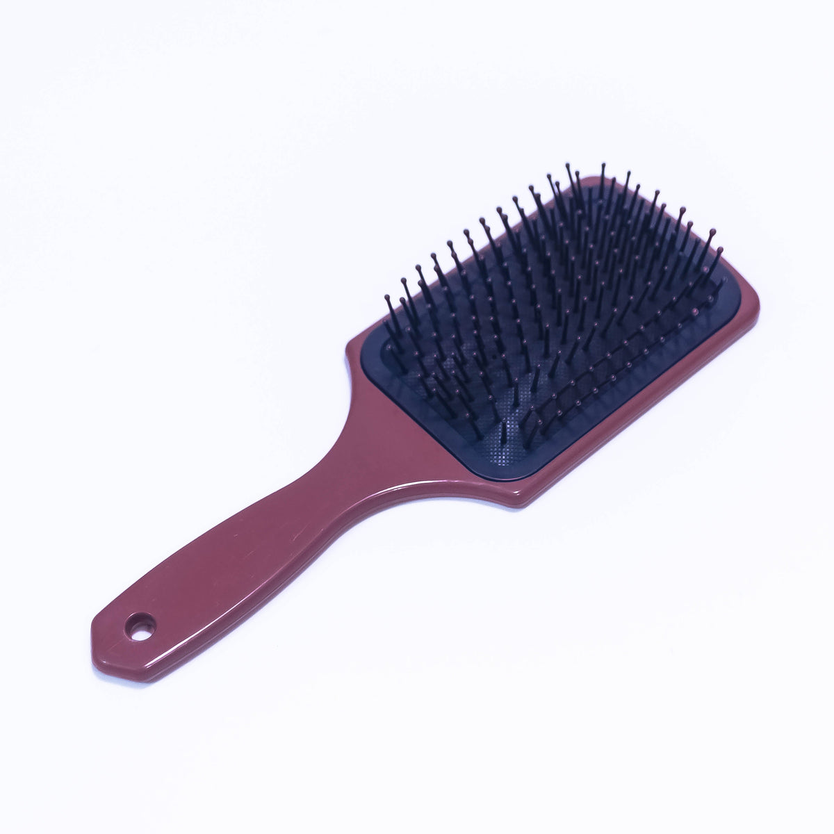 Printed mauve Sauvé color hair brush by Zoni Stores, with textured bristles and ergonomic handle for styling and detangling hair.