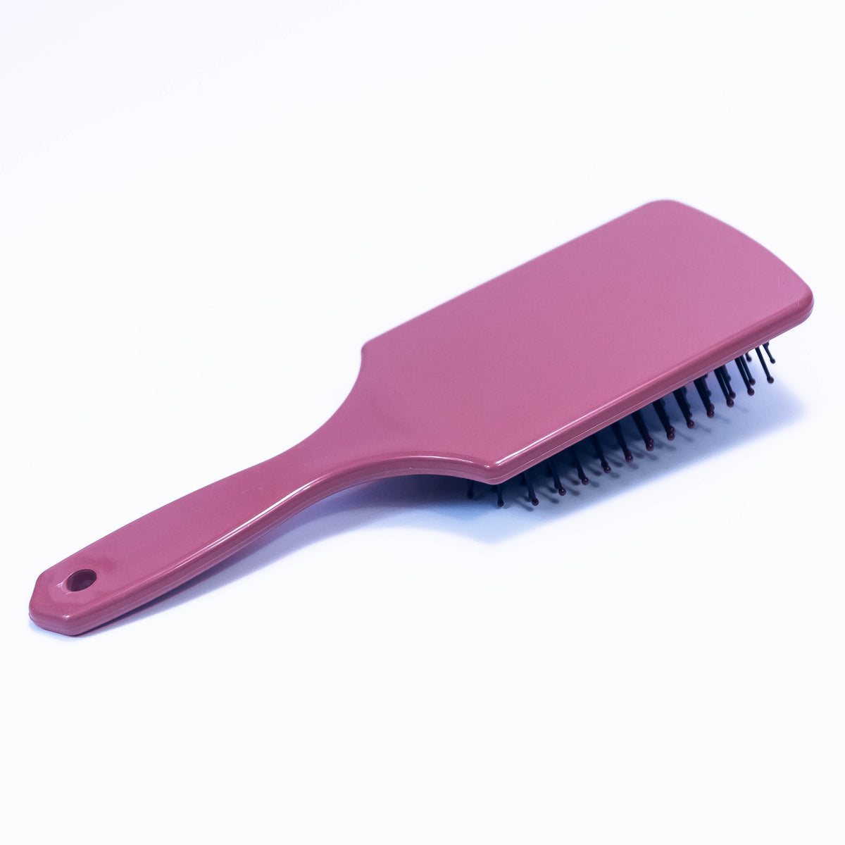 Printed mauve Sauve color hair brush by Zoni Stores with textured handle and bristles for gentle hair detangling.