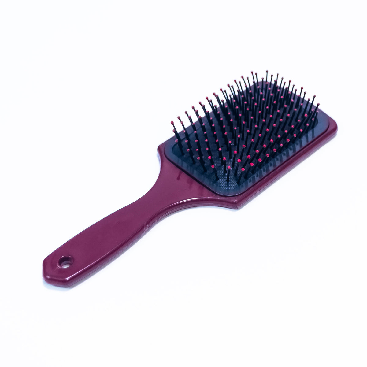 Printed Cordova Burgundy hair brush from Zoni Stores with ergonomic handle and soft bristles for gentle hair styling.
