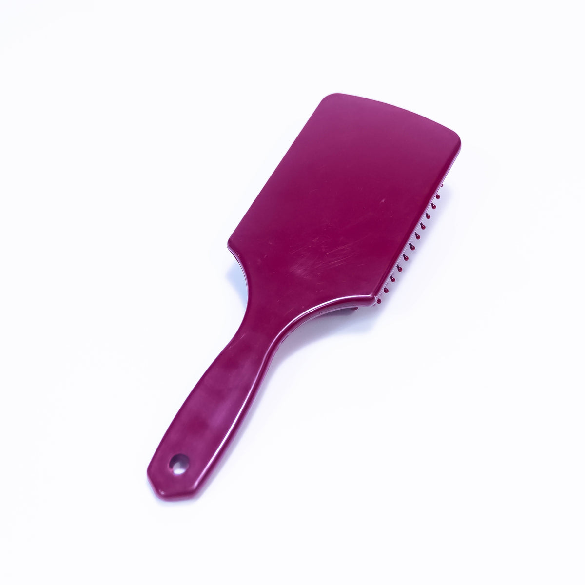Printed Cordova Burgundy Hair Brush by Zoni Stores, showing close-up of the textured design and bristle layout.