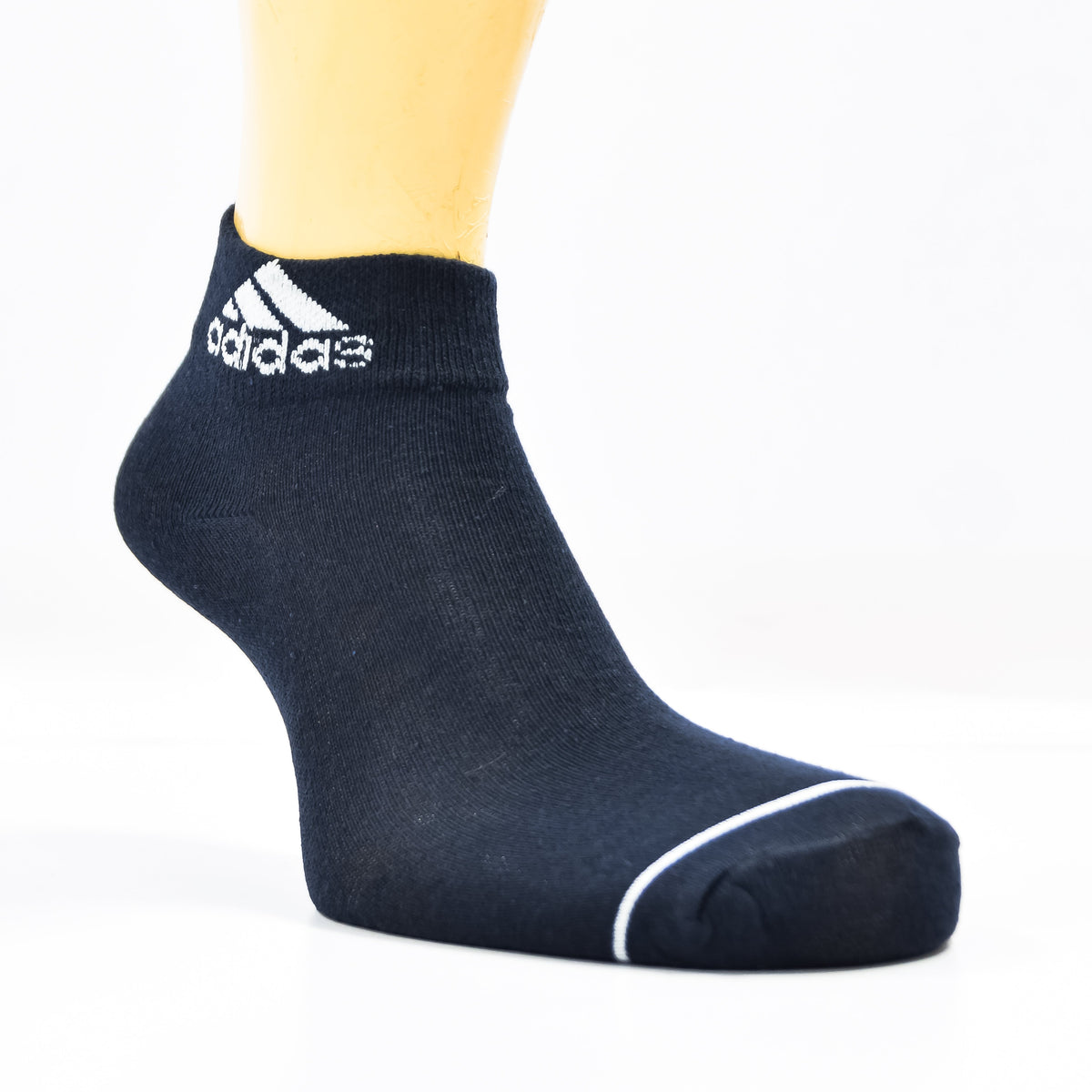 Set of three black Adidas ankle socks with white stripes, displayed laid flat on a white background.
