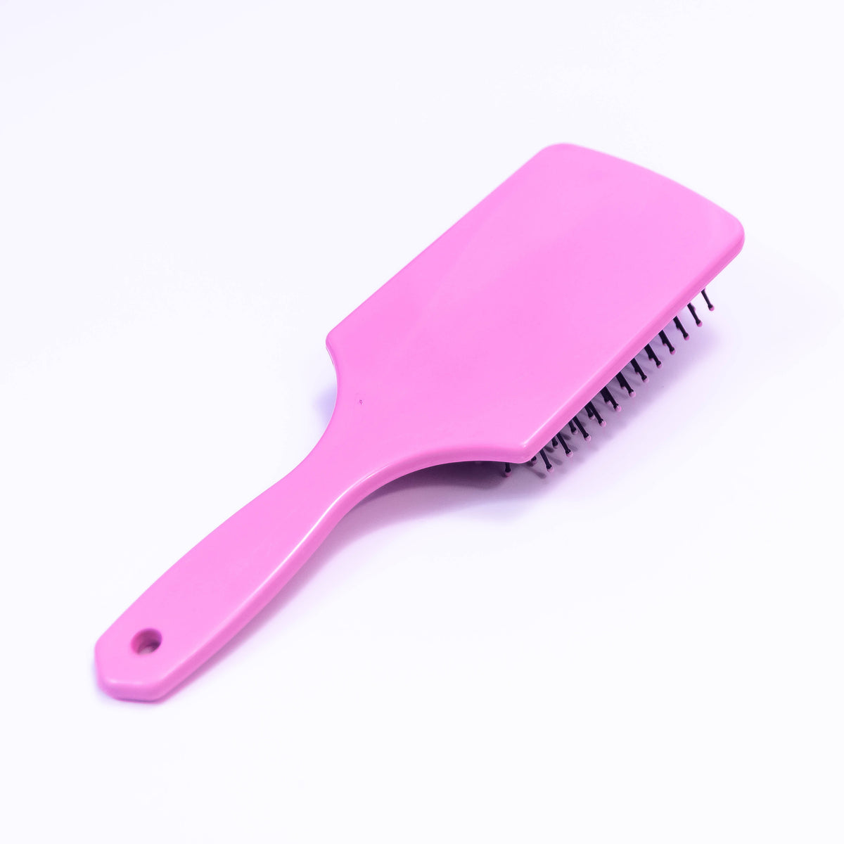 Printed light pink hair brush from Zoni Stores with a textured design, suitable for detangling and styling hair.
