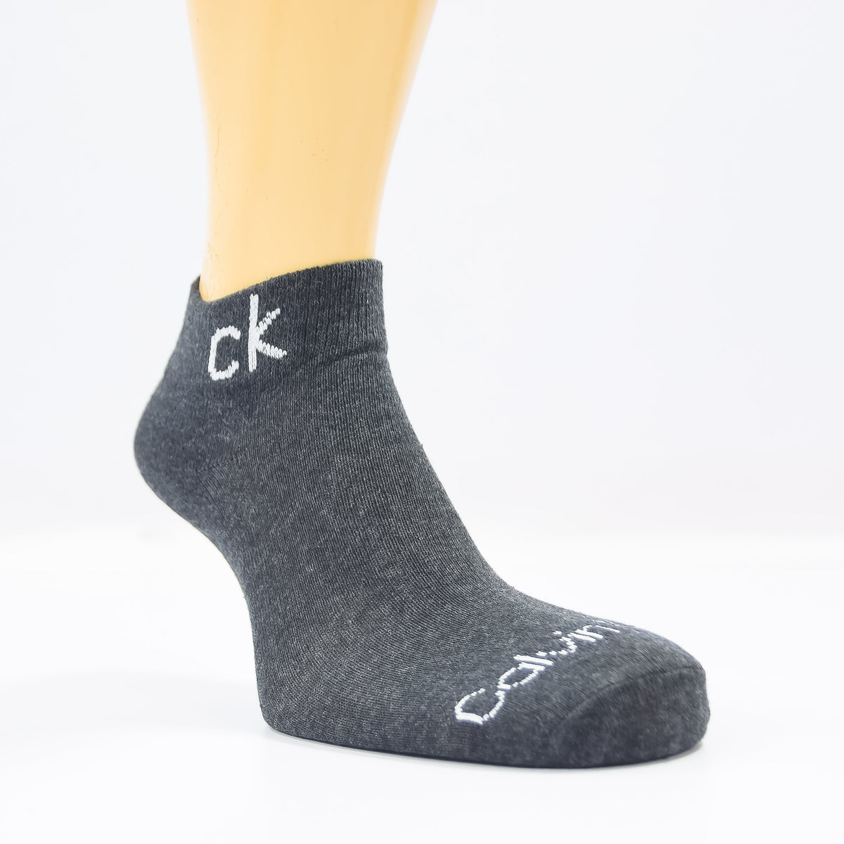 Three pairs of Zoni Stores branded C-K ankle socks in black, neatly folded, showcasing their comfortable ankle-length design.