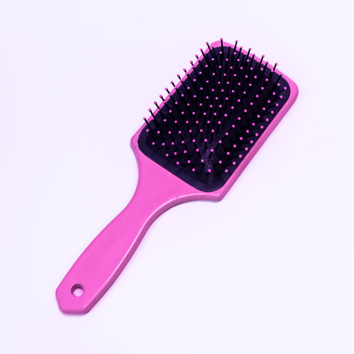 Printed Phoenix Fire hair brush by Zoni Stores, showing colorful design and bristle array on smooth handle.