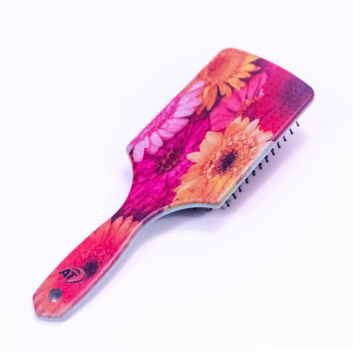 Spring flower printed hair brush by Zoni Stores with colorful floral design and ergonomic handle.