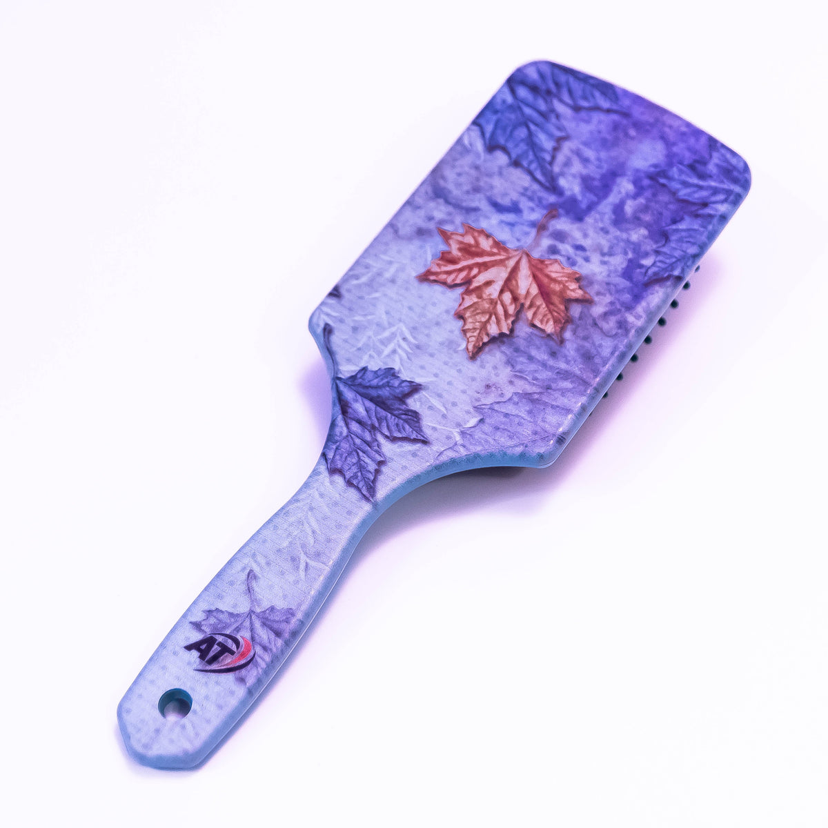 Winter leaf printed hair brush by Zoni Stores, showcasing a stylish design with bristles for detangling and styling hair.