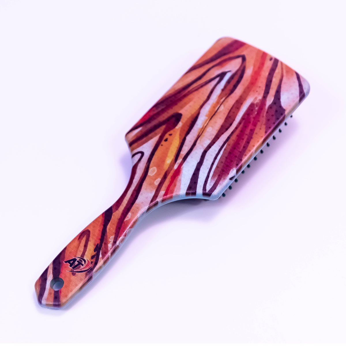 Tiger stripe printed hair brush by Zoni Stores with ergonomic design and colorful tiger stripe pattern for detangling hair.
