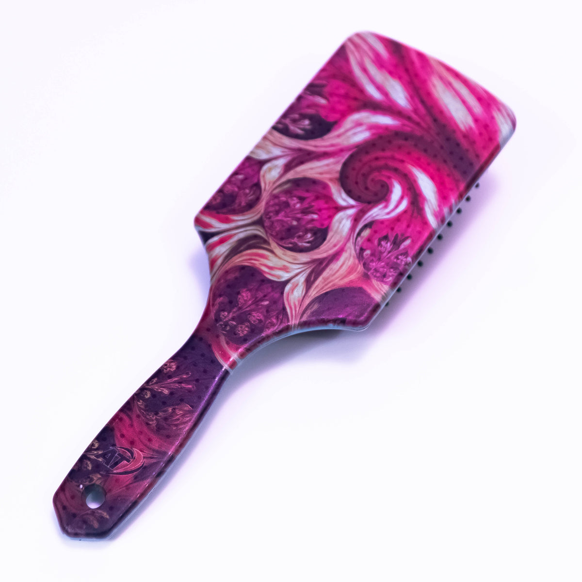 Printed hair brush with rose buds design from Zoni Stores, showing the textured bristles and floral pattern on the handle.