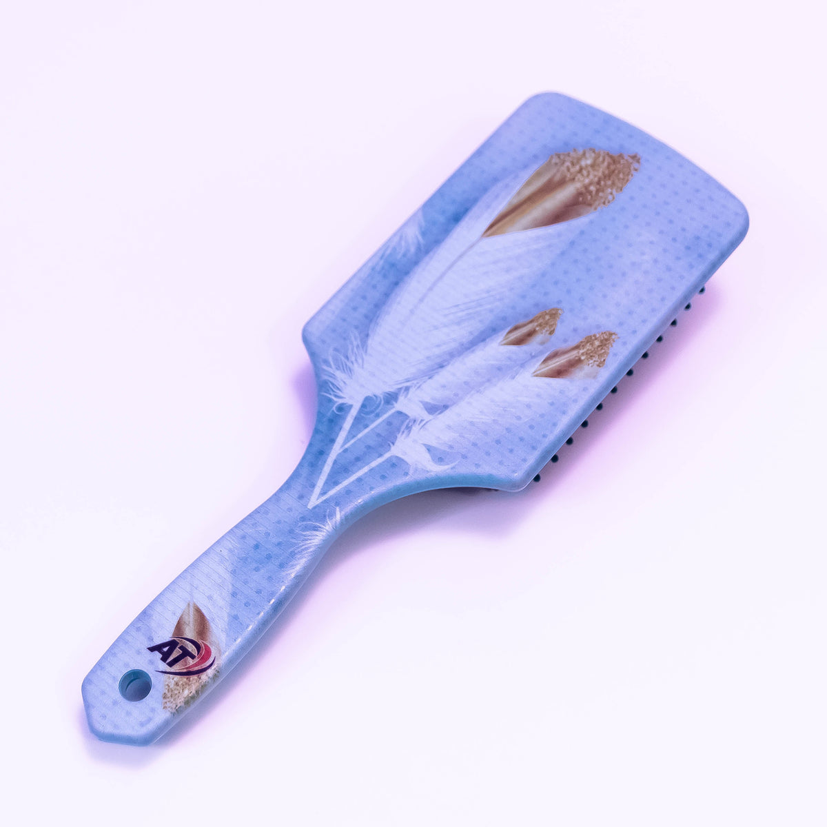 White feather printed hair brush by Zoni Stores with smooth bristles and ergonomic handle.