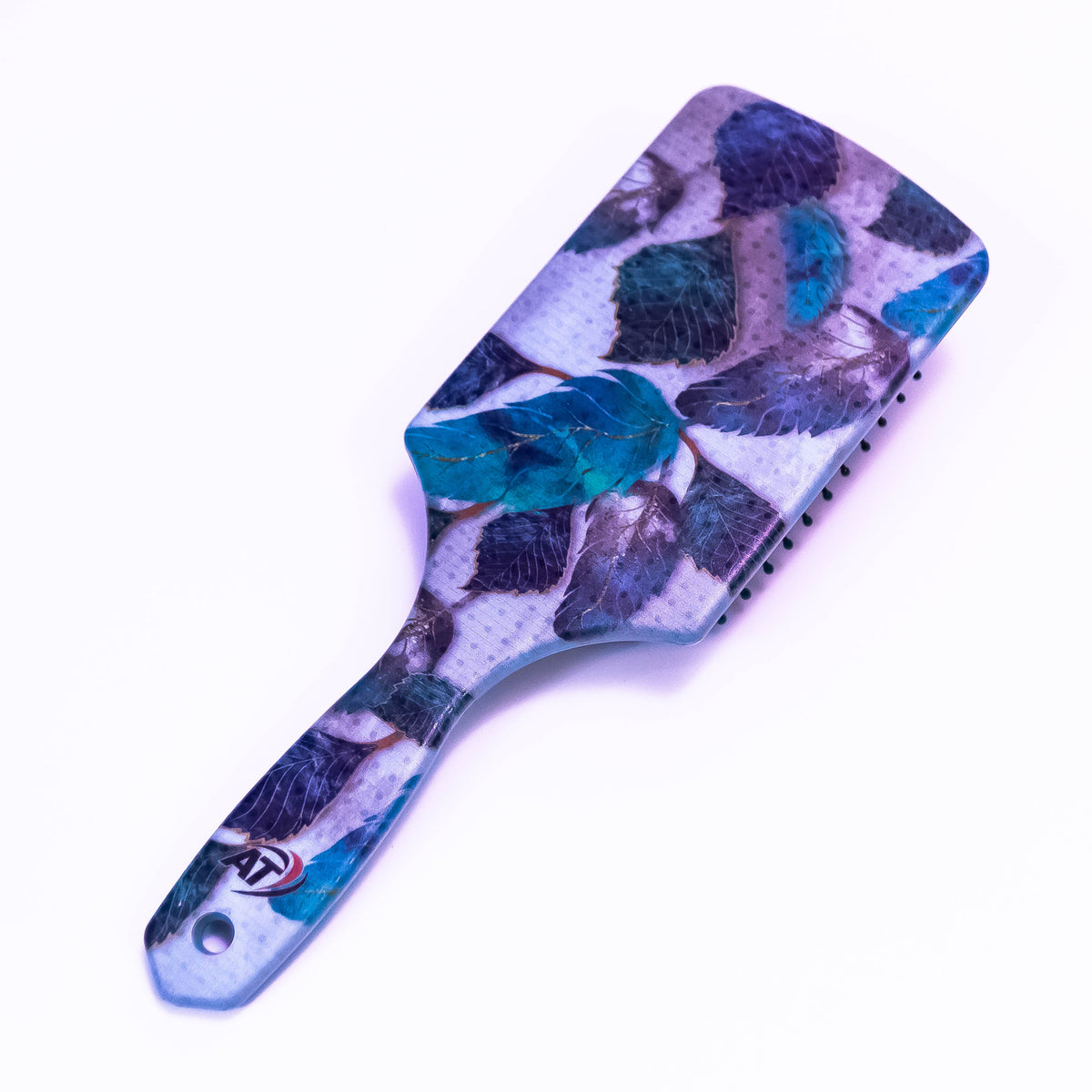 Blue leaf printed hair brush by Zoni Stores with a ergonomic design and colorful leaf pattern on the bristles.