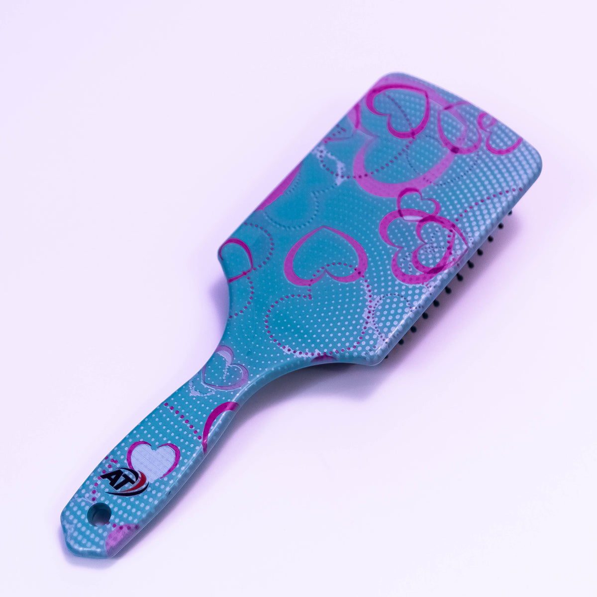 Blue Heart Printed Hair Brush by Zoni Stores, showing close-up of the colorful heart design on the bristle side.