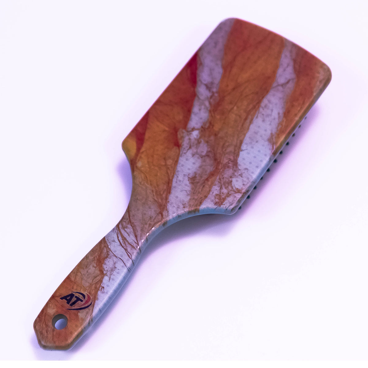 Printed hair brush by Zoni Stores with colorful stream flow design, featuring bristles for detangling and styling hair.