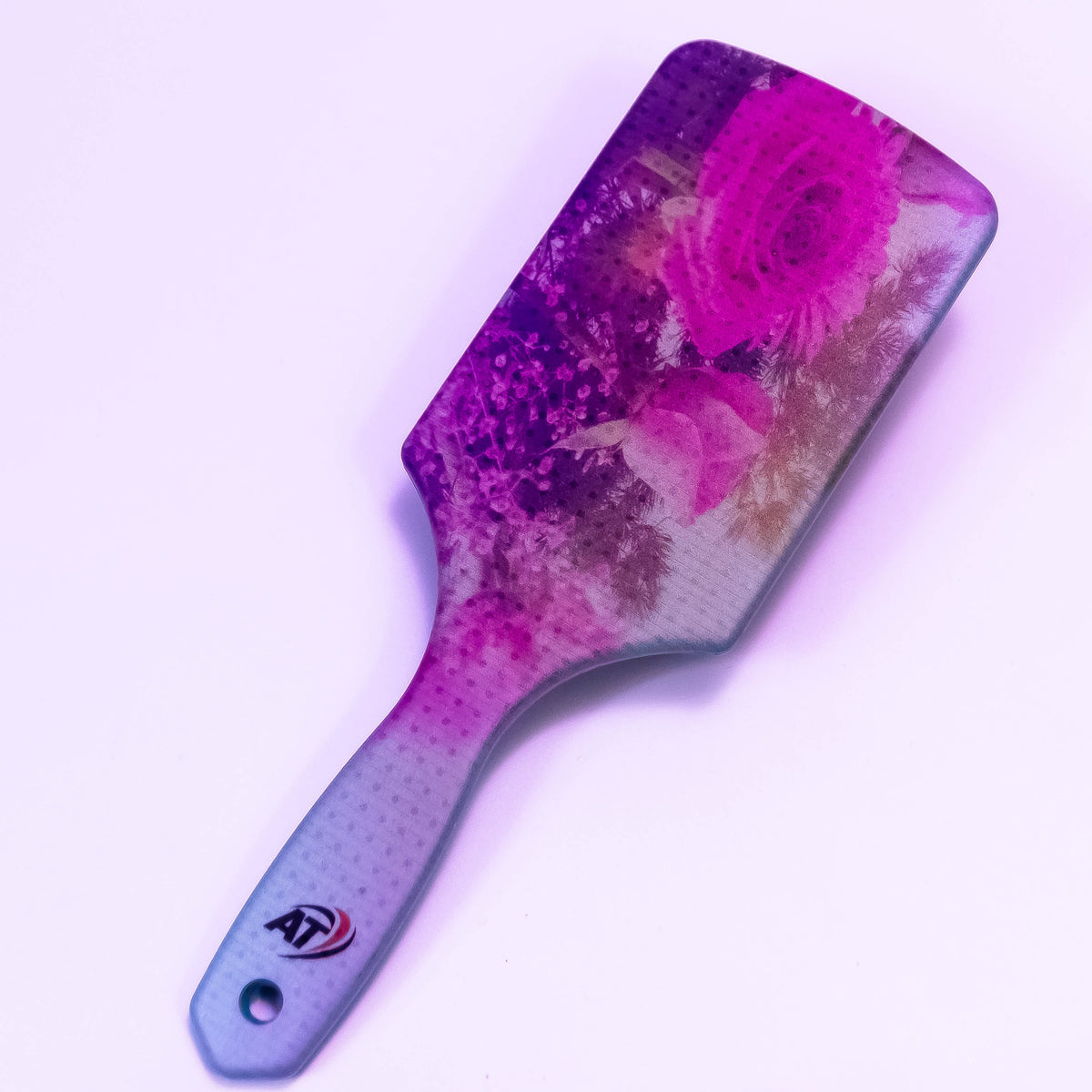 Pink rose printed hair brush by Zoni Stores with a comfortable handle and floral design for gentle hair grooming.