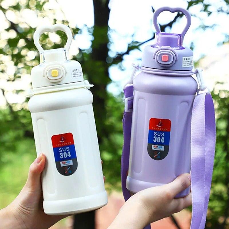 Portable school water bottle for kids featuring a vacuum insulated travel design being held outdoors.