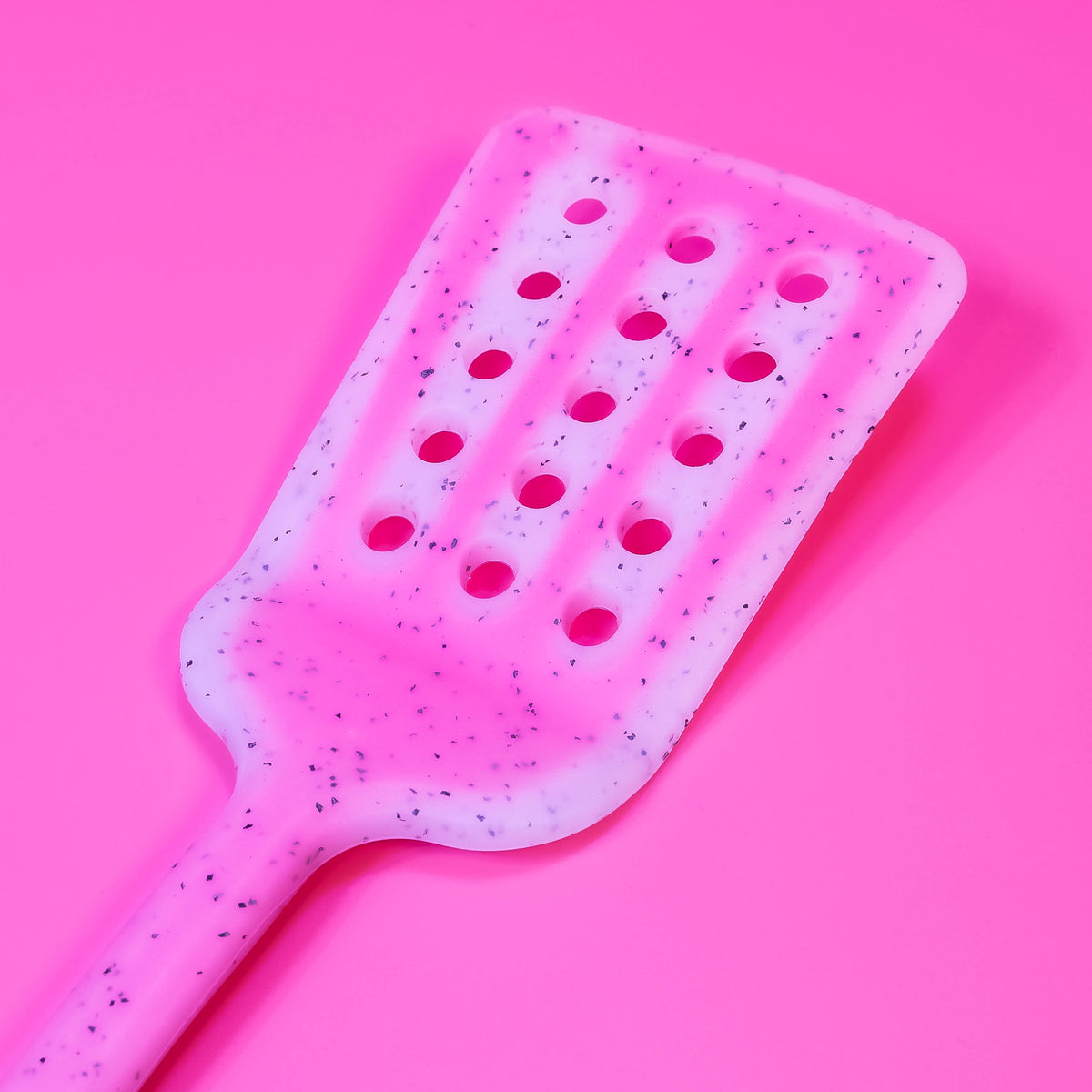 Colorful silicone slotted turner by Zoni Stores, long handle for flipping and serving in the kitchen, with slotted design for draining.