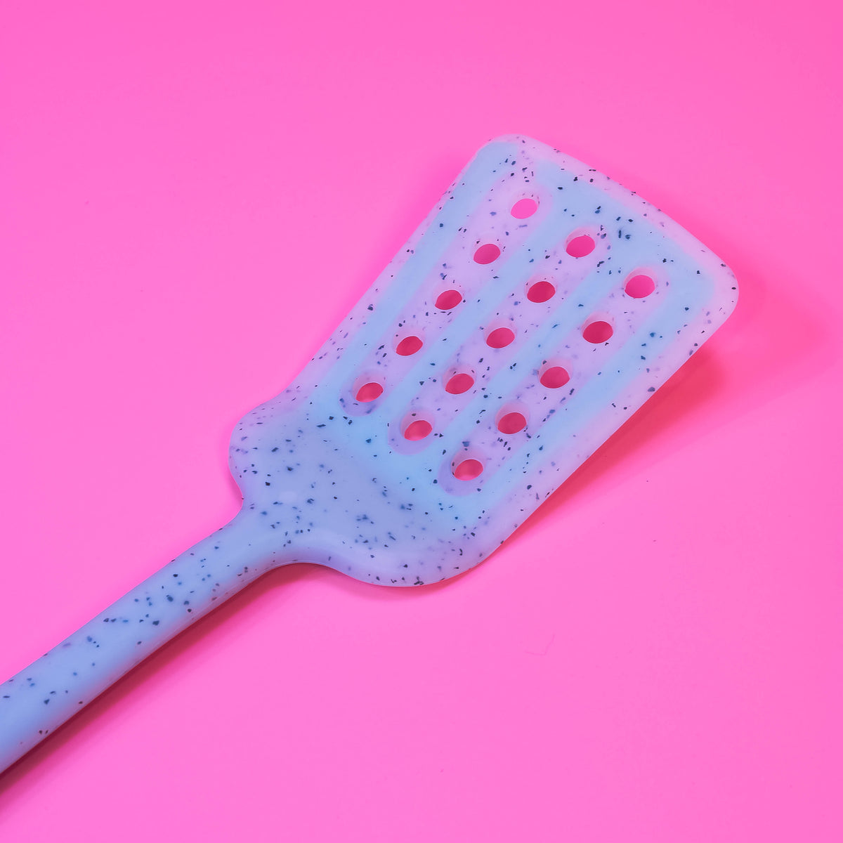 Colorful silicone slotted turner from Zoni Stores, long kitchen spatula with slots for flipping and serving food.