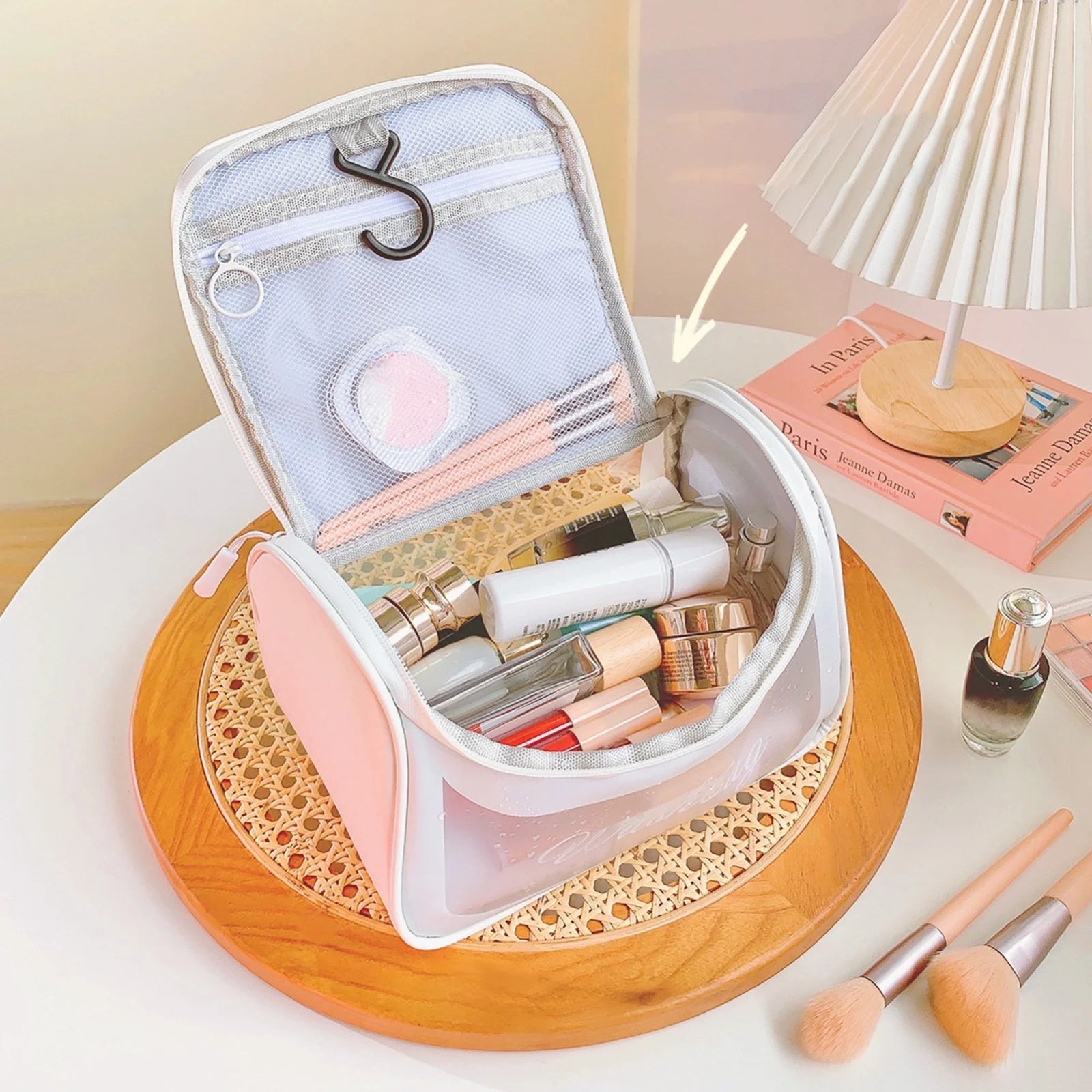 Waterproof PU leather cosmetic organizer showing double zippers and a transparent front window displaying makeup palettes inside.