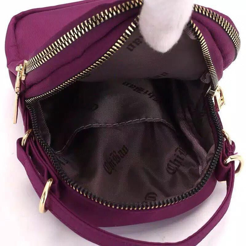 Close-up of a vertical mini shoulder bag featuring a prominent front zipper on ZoniStores website