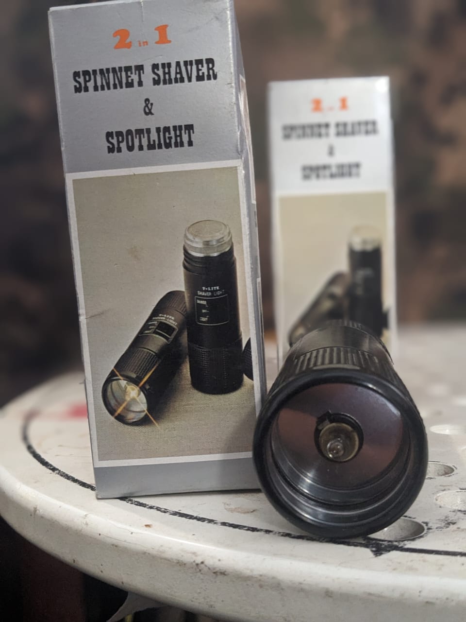 Battery-operated portable LED torch displaying its illuminated front lens