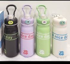 Four kids insulated water bottles in black, purple, light green, and white with large handle loops and leakproof lids.