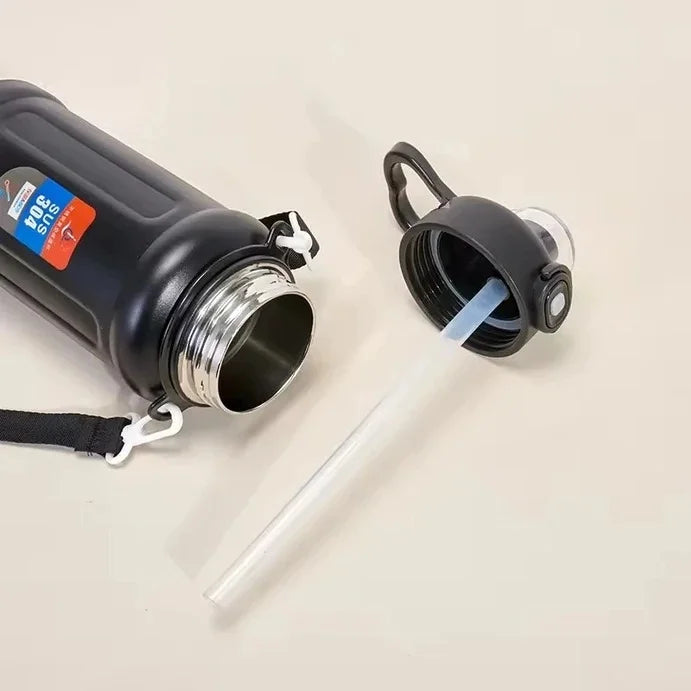 Vacuum insulated school water bottle with a separate pop-up straw lid featuring a heart-shaped handle.