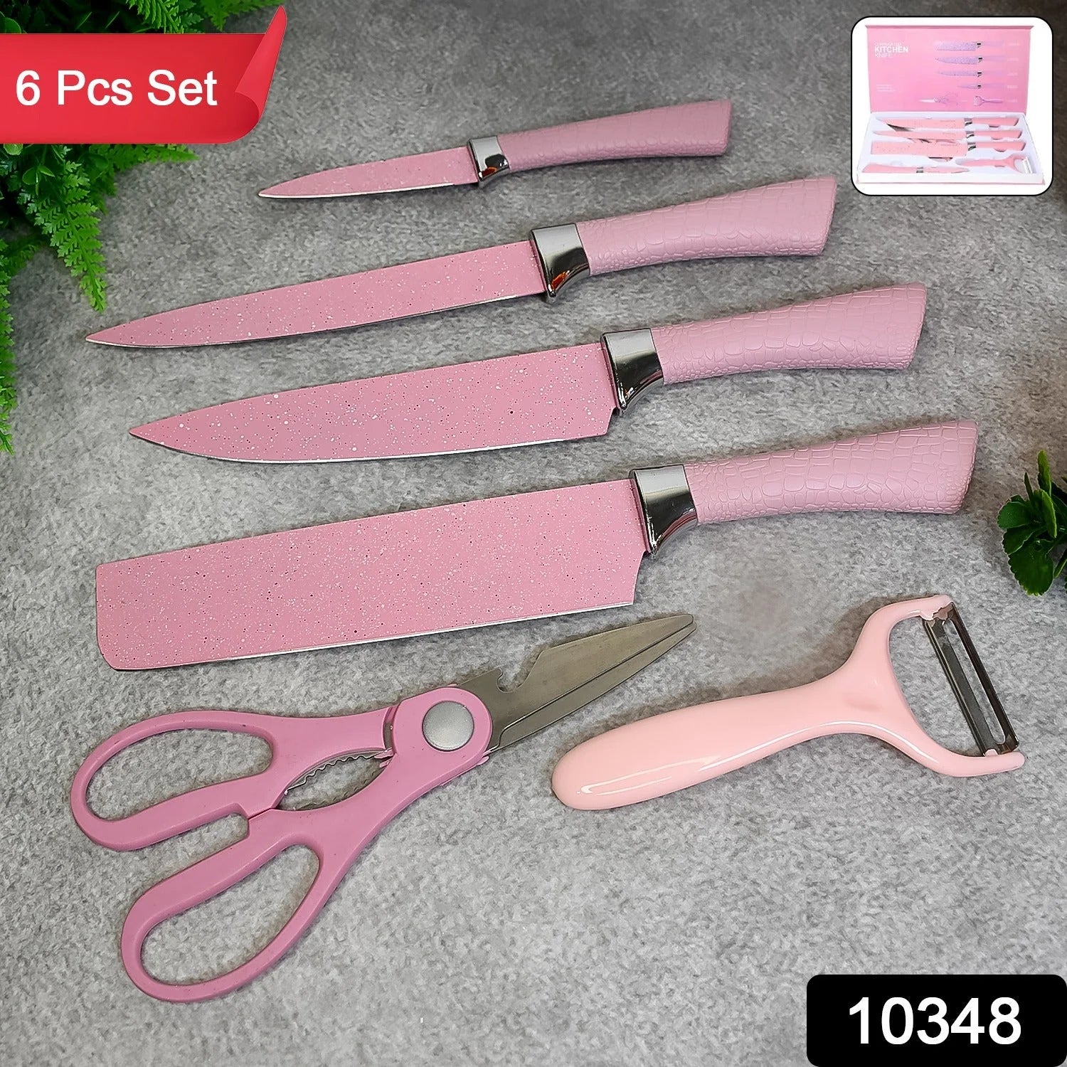 Stainless steel kitchen knife set displayed on a wooden block for home cooking in Pakistan